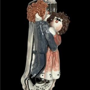 SIGNED WHIMSICAL CERAMIC MEZUZAH SHOWING COUPLE DANCING AT THEIR WEDDING SCROLL